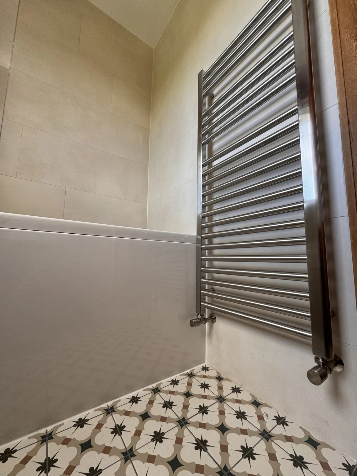 Heated towel rail beside the bath