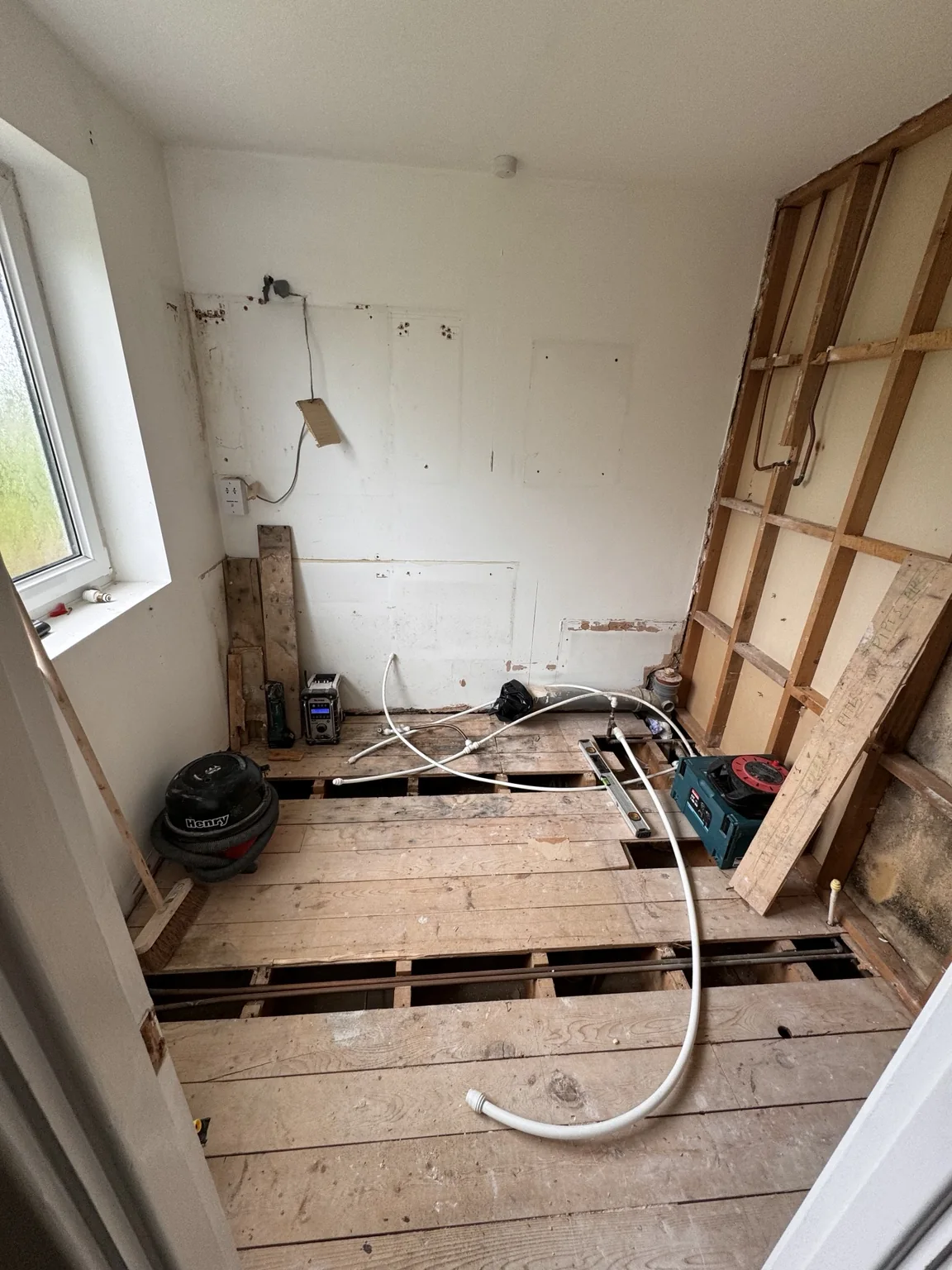 During refurbishment: the stripped room and exposed floorboards