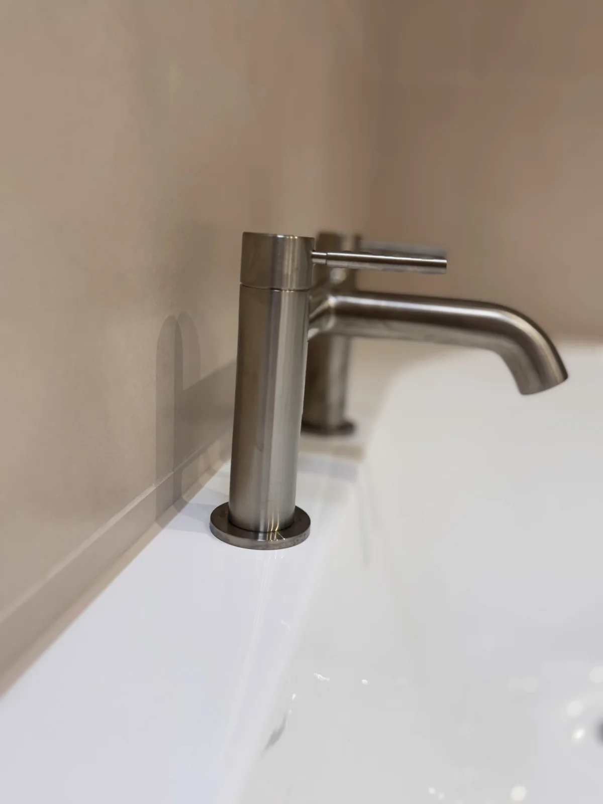 Close-up of the brushed-metal basin mixer